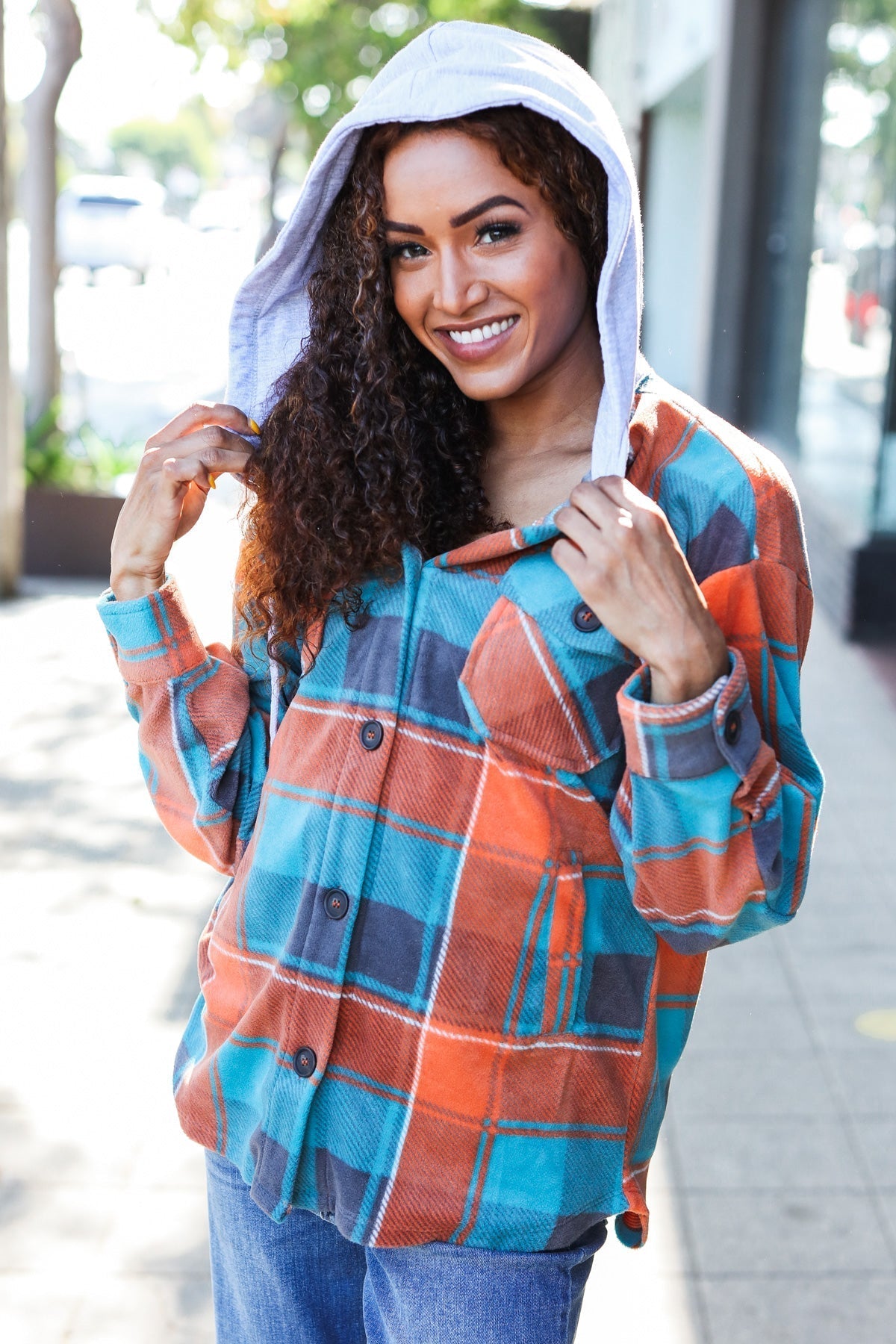 Karin | Standout fleece hoodie jacket with a check pattern in teal and orange