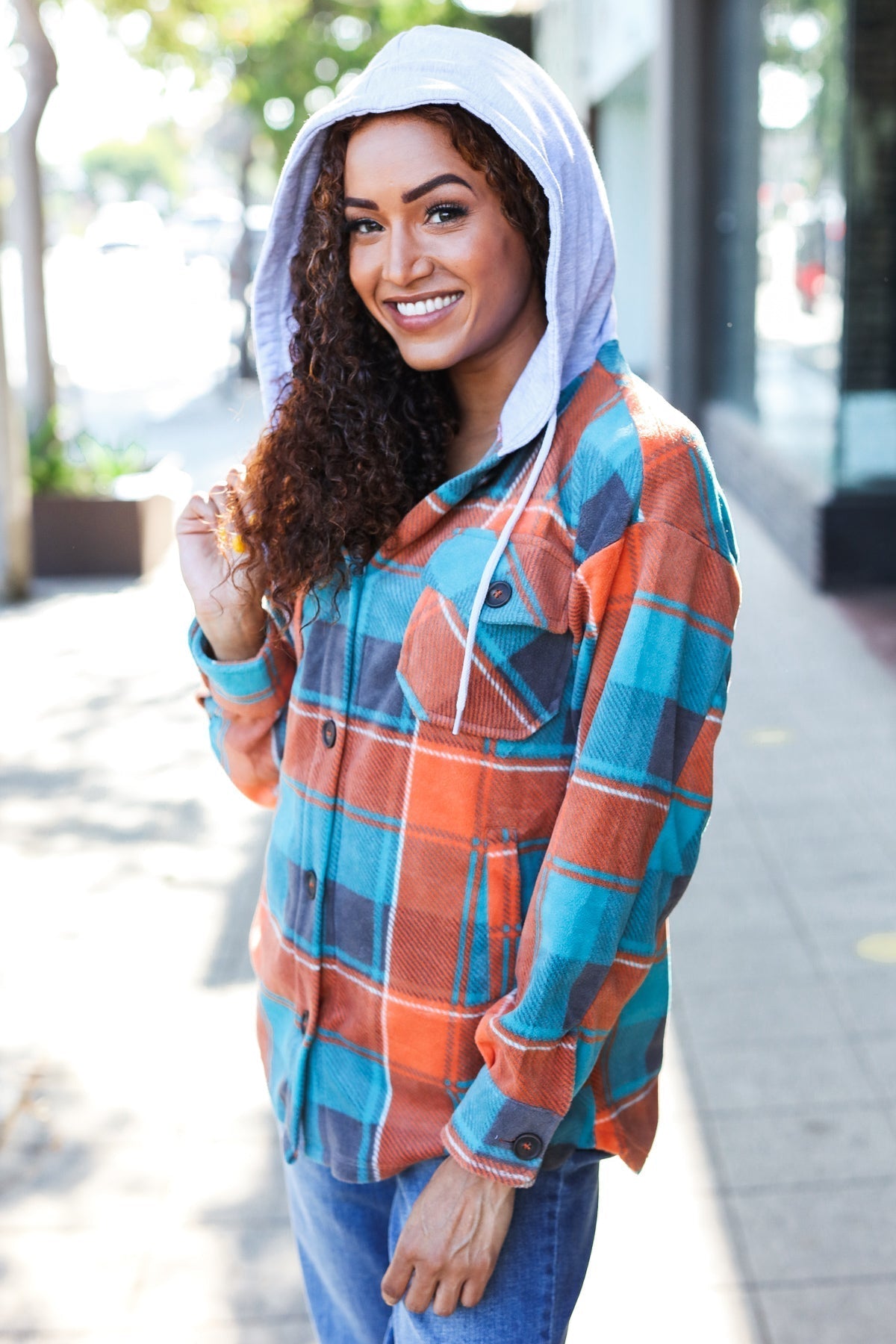 Karin | Standout fleece hoodie jacket with a check pattern in teal and orange