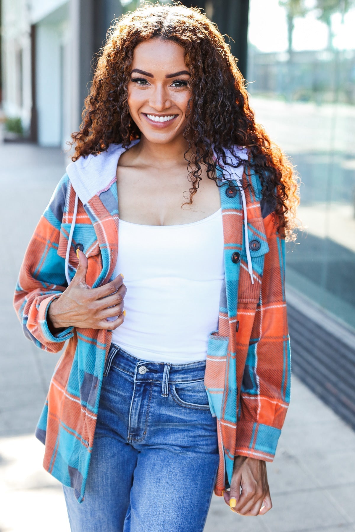 Karin | Standout fleece hoodie jacket with a check pattern in teal and orange