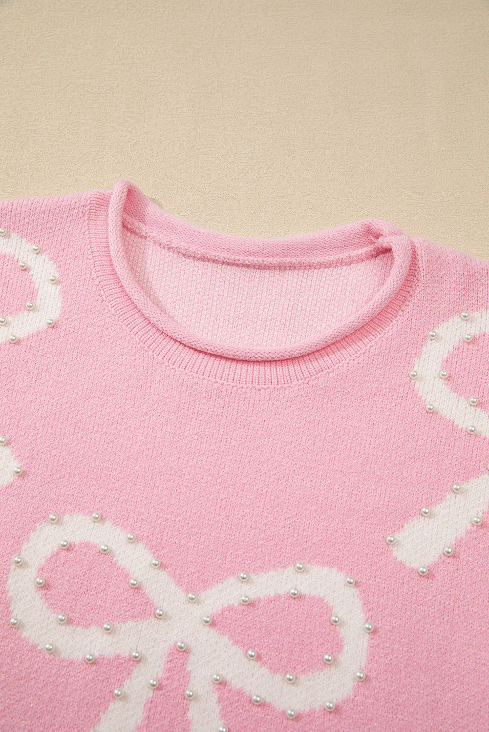 Yessica | Long-sleeved crew neck sweater with pearl detail and bow