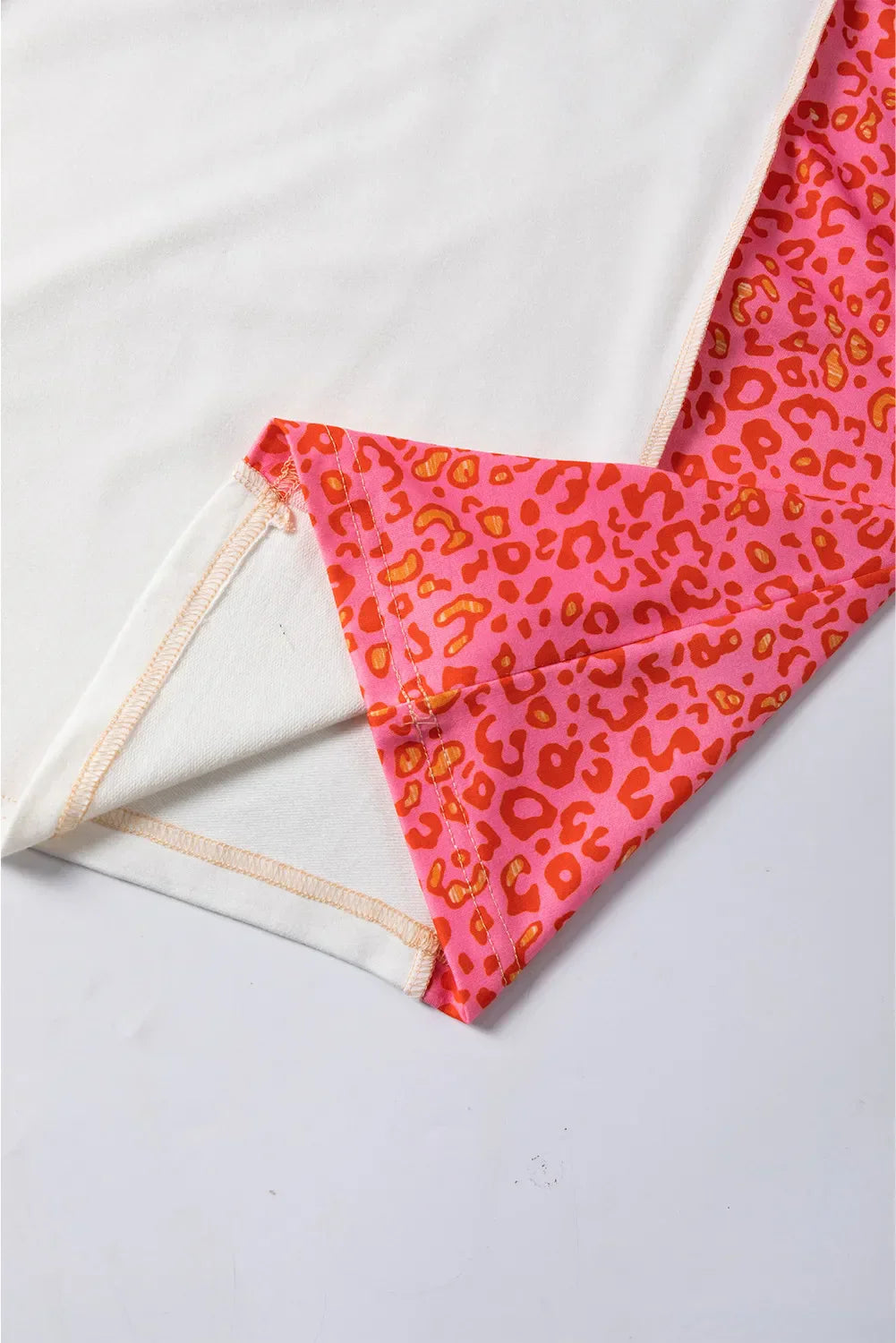 Ida | Exposed seam color block leopard print crew neck top
