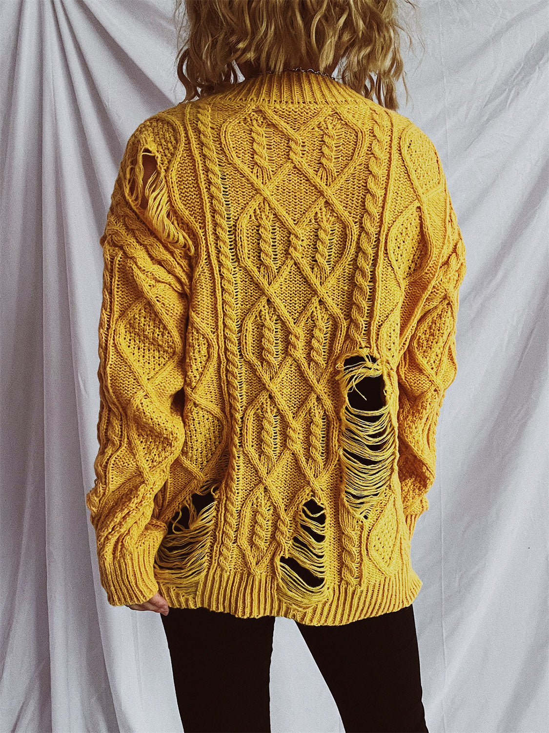 Clara | Long-sleeved, crew-neck, distressed cable-knit sweater