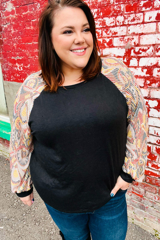 Giulia | Black structured top with bubble sleeves and abstract print