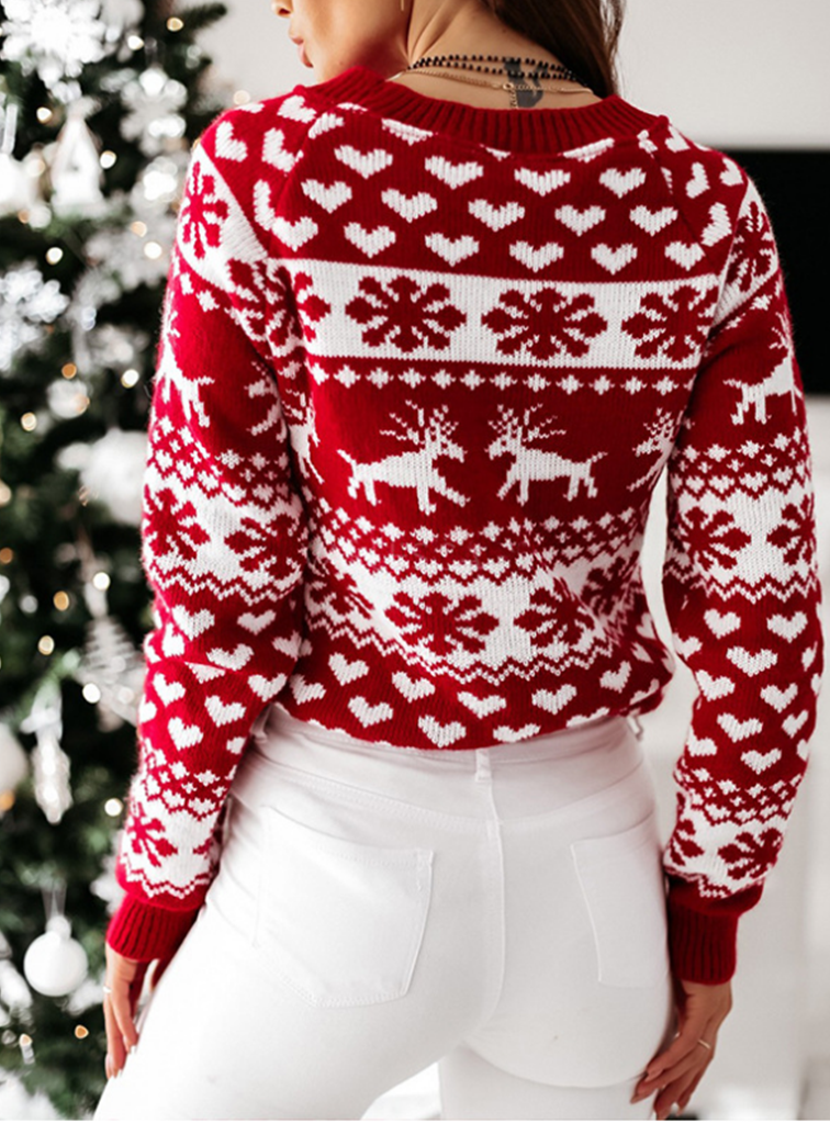 Yara | Festive sweater with a reindeer and snowflake design.